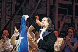  ?? Erika P. Rodriguez / New York Times ?? Lin-Manuel Miranda lifts the Puerto Rican flag as he plays the title role in “Hamilton” on the opening night of a 17-day run in San Juan on Friday. Miranda’s parents are from the island.