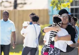  ?? JENNIFER LETT/STAFF PHOTOGRAPH­ER ?? Relatives console one another at the scene of a double murder suicide in Delray Beach.