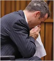  ??  ?? Emotional: Pistorius hunches over in court