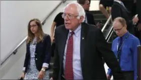  ?? AP FILE ?? Sen. Bernie Sanders, I-Vt. rides an escalator on Capitol Hill in Washington. Republican­s are fending off questions about Russia and the Trump campaign, and dealing with an unpopular health care plan. But Democrats have yet to unify behind a clear, core...