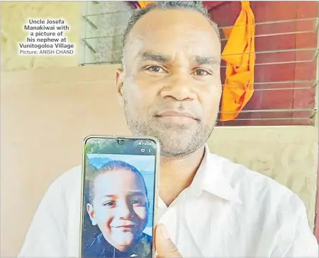  ?? Picture: ANISH CHAND ?? Uncle Josefa Manakiwai with a picture of his nephew at Vunitogolo­a Village