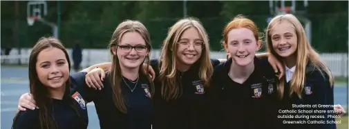  ?? ?? Students at Greenwich Catholic School share smiles outside during recess. Photo: Greenwich Catholic School