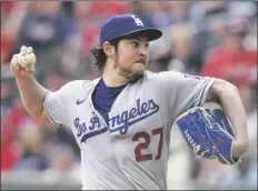  ?? BRYNN ANDERSON/AP ?? LOS ANGELES DODGERS STARTING PITCHER TREVOR BAUER delivers in the first inning of a game against the Atlanta Braves, June 6, 2021, in Atlanta.