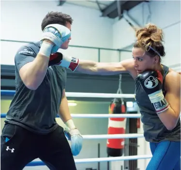  ??  ?? LATEST RECRUIT: Cameron lets fly at the pads of her trainer, Shane Mcguigan