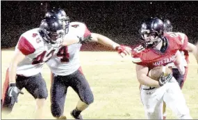  ?? PHOTO BY RICK PECK ?? McDonald County running back Jake Will gets outside of Lamar’s Michael Henderson (48) and Aaron Moenning (4) in the Mustangs’ 56-0 loss on Friday night.
