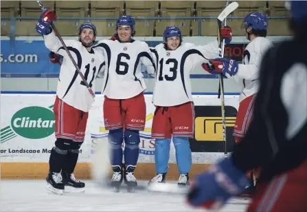  ?? MATHEW MCCARTHY WATERLOO REGION RECORD ?? From left, Justin McEneny, Kole Sherwood and Riley Damiani celebrate a goal during Kitchener Rangers practice at The Aud on Wednesday. The Rangers start their playoff series against the Sarnia Sting in Kitchener on Friday.