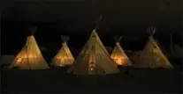  ?? GUY REYNOLDS, TNS ?? Fires burn in all five of the teepees in the predawn hour at El Cosmico in Marfa, Texas.
