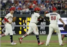  ?? MATT SLOCUM — THE ASSOCIATED PRESS ?? Phillies third baseman Maikel Franco (7) and relief pitcher Seranthony Dominguez (58) celebrate after Franco fielded a bases-loaded grounder by Baltimore’s Chris Davis during the eighth inning on Tuesday.