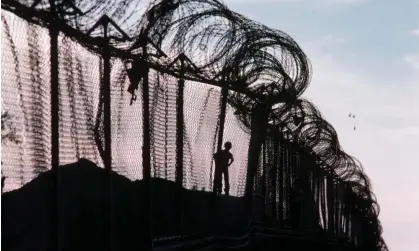  ?? ?? A child runs along the US-Mexico border fence in Calexico, California. Photograph: Stephanie Maze/Getty Images