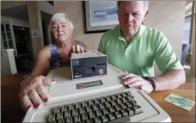  ?? ELAINE THOMPSON — THE ASSOCIATED PRESS ?? Kathy and Steve Dennis display their 1980s-era Apple II+ computer bought for their then young sons in Bellevue, Wash. Three decades ago they never heard the phrase “screen time,” nor did they worry much about limiting the time the kids spent with technology, considerin­g the computer an investment in their future. Things have changed with their grandkids and their phones.