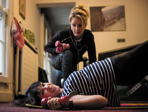  ??  ?? THRILLED SKINNY: Victoria Mary Clarke working out with personal trainer Laura Gibson. Photo: Mark Condren