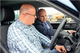  ??  ?? COMFORT Adam Corby, of Motorline Skoda, talks our man Milne through the Dynamic Chassis Control settings, accessed via touchscree­n