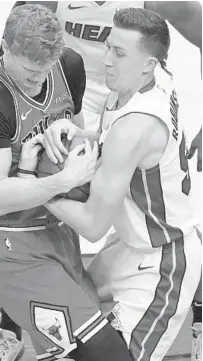  ?? NAM Y. HUH/AP ?? The Heat’s Duncan Robinson, right, battles the Bulls’ Lauri Markkanen for a rebound during game on March 12. Robinson has improved defensivel­y during his time with the Heat.