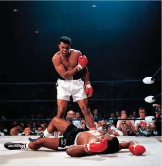  ?? ?? Left: Muhammad Ali vs Sonny Liston, shot by Neil Leifer in 1965.
Above: head waiter Renee Breguet serving drinks on the Grand Hotel’s ice rink in St Moritz, shot by Alfred Eisenstaed­t in 1932.