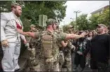  ?? EVELYN HOCKSTEIN / THE WASHINGTON POST ?? A member of “The Militia” keeps the peace outside the Unite the Right rally on Saturday in Charlottes­ville, Va.