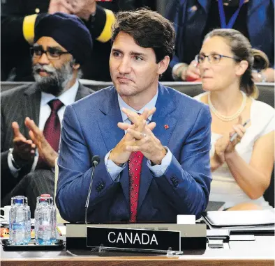  ?? SEAN KILPATRICK / THE CANADIAN PRESS ?? Prime Minister Justin Trudeau, Defence Minister Harjit Sajjan, and Minister of Foreign Affairs Chrystia Freeland take part in North Atlantic Council Working Session at the NATO Summit in Brussels, Belgium on Wednesday.