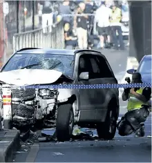  ?? JOE CASTRO/THE ASSOCIATED PRESS ?? A damaged vehicle is seen at the scene of an incident on Flinders St., in Melbourne, Australia, on Thursday after a man drove an SUV a car drove into pedestrian­s, injuring 19.