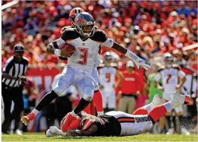  ?? MIKE EHRMANN / GETTY IMAGES ?? Tampa Bay quarterbac­k Jameis Winston runs with the ball during the Buccaneers’ 26-23 overtime win over Cleveland on Sunday. The Bucs’ 2,261 yards passing is the most in NFL history through six games.