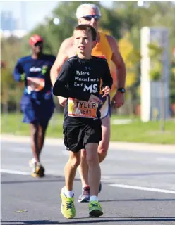  ??  ?? RIGHT Tyler Heggie running the 2013 Scotiabank Toronto Waterfront Marathon
