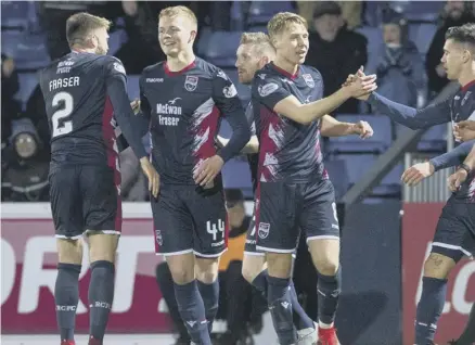  ??  ?? 2 Ross County’s Tom Grivosti, second from left, celebrates with his team-mates after scoring what proved to be the winning goal.