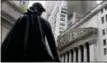  ?? RICHARD DREW — THE ASSOCIATED PRESS FILE ?? The statue of George Washington on the steps of Federal Hall faces the facade of the New York Stock Exchange.