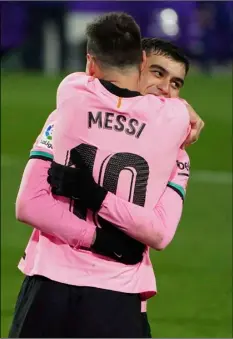  ?? Cesar Manso/Pool via AP ?? Barcelona’s Lionel Messi (left) celebrates with Pedri after scoring his side’s third goal during a Spanish La Liga soccer match between Valladolid and Barcelona at the Jose Zorrilla stadium in Valladolid, Spain, on Dec. 22.