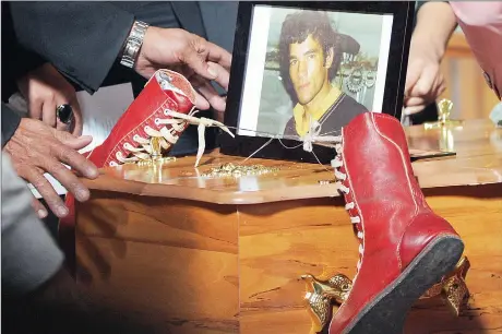  ?? Picture: BRENTON GEACH ?? ‘REST IN PEACE’: A pair of red boxing boots, handmade by Michael Volkwyn, was placed on his coffin yesterday.