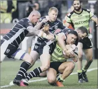  ??  ?? Halifax’s James Woodburn-Hall is tackled by Feathersto­ne’s Anthony Thackeray and Richard Moore.