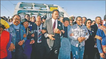  ?? (File Photo/AP/Jamie Sturtevant) ?? Civil rights figures lead marchers in March 1990 across the Edmund Pettus Bridge during the recreation of the 1965 Selma to Montgomery march in Selma, Ala. From left are Hosea Williams of Atlanta, Georgia Congressma­n John Lewis, the Rev. Jesse Jackson, Evelyn Lowery, SCLC President Joseph Lowery and Coretta Scott King.