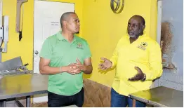  ?? PHOTO BY HERBERT MCKENIS ?? Agricultur­e Minister Floyd Green (left) chats with David Robb, operator of the JDJR Hyde Farm in Clarks Town, Trelawny, during a tour of the animalfarm­ing facility on Thursday.