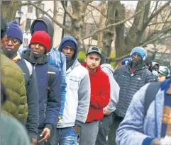  ?? ?? More giveaways: Migrants line up for free food at Tompkins Square Park, near St. Brigid School, where they apply for lodging.