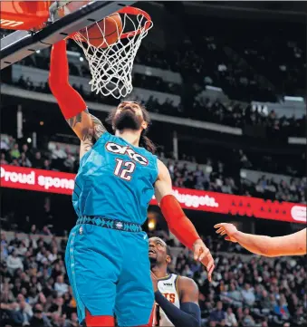  ?? [AP PHOTO/ DAVID ZALUBOWSKI] ?? Oklahoma City Thunder center Steven Adams dunks during Tuesday night's NBA game in Denver.