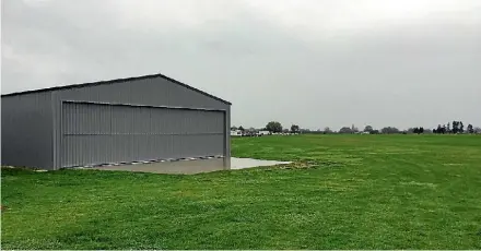  ?? LAWRENCE GULLERY ?? A gliding club contests this new hangar was built across a small section of the aerdrome’s runway.