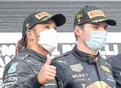  ?? AFP ?? Mercedes’ Lewis Hamilton, left, and Red Bull’s Max Verstappen pose on the podium after the Emilia Romagna Grand Prix at Imola on Sunday.