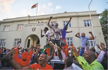  ?? Ben Curtis / Associated Press ?? The capital, Harare, erupted in jubilation after news spread that 93-year-old Robert Mugabe had resigned.