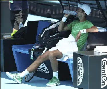  ?? DITA ALANGKARA — THE ASSOCIATED PRESS ?? Novak Djokovic takes a drink during a practice session ahead of the Australian Open on Jan. 19in Melbourne, Australia.