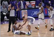  ?? RICH PEDRONCELL­I — THE ASSOCIATED PRESS ?? Sacramento Kings guard Buddy Hield, sitting, is helped up by Tyrese Haliburton, after he was fouled while making a 3- point basket during the second half Wednesday against the Chicago Bulls in Sacramento. Hield sank a free throw to complete a 4- point play as the Kings went on to win 128- 124.