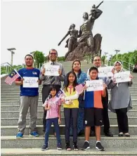  ??  ?? Together in Africa: Malaysians living in Dakar, Senegal, showing their support in front of the African Renaissanc­e Monument built to symbolise the rebirth of Africa.