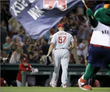  ?? CHARLES KRUPA — THE ASSOCIATED PRESS ?? Phillies relief pitcher Luis Garcia (57) heads to the clubhouse after giving up a game-winning, RBI double to Boston’s Blake Swihart during the 13th inning at Fenway Park in Boston, Monday. The Red Sox defeated the Phillies 2-1.