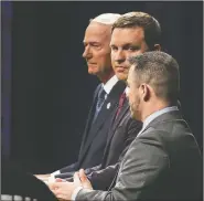  ?? Arkansas Democrat-Gazette/MITCHELL PE MASILUN ?? Candidates for governor Asa Hutchinson (from left) and Jared Henderson listen Friday to Mark West answer a question during a debate at the Donald W. Reynolds Performanc­e Hall in Conway.