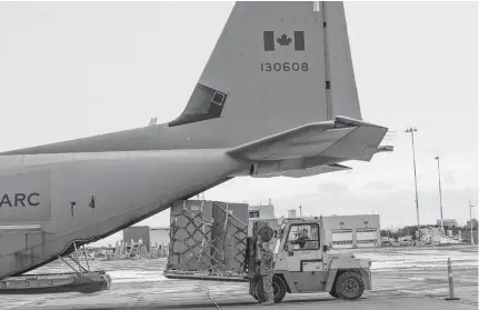  ?? HANDOUT VIA REUTERS ?? Special freezers for coronaviru­s disease vaccine storage are loaded onto a transport aircraft in Ottawa on Saturday.