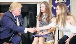  ?? MANDEL NGAN/AFP/GETTY IMAGES ?? President Trump speaks with Marjory Stoneman Douglas High School students Ariana Klein, right, and Carson Abt at Wednesday’s listening session on gun violence.