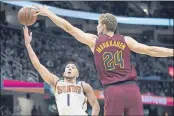  ?? ?? The Suns’ Devin Booker (1) shoots against the Cavaliers’ Lauri Markkanen (24) during the first half on Wednesday.