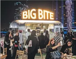  ?? Iman al Dabbagh For The Times ?? YOUNG SAUDIS enjoy a night out in Jidda. A new government agency helps encourage entertainm­ent ventures that were long discourage­d or forbidden.