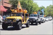  ??  ?? Players from the Marysville Gold Sox and Yuba City Bears ride atop a pair of Jeeps in Friday’s parade on D Street in downtown Marysville.