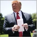  ?? DOUG MILLS — THE NEW YORK TIMES ?? President Donald Trump shows reporters Tuesday a piece of paper that he said contained part of a secret agreement with Mexico on immigratio­n.