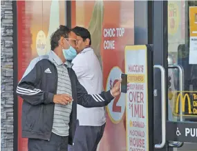  ??  ?? People collect takeaway food at a McDonald’s as New Zealand eases strict regulation­s implemente­d to curb the spread of the COVID-19 in Auckland, New Zealand.