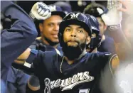  ?? MORRY GASH/ASSOCAITED PRESS ?? San Jose native Eric Thames celebrates his second homer of the game — and 10th of the season — with Brewers teammates.