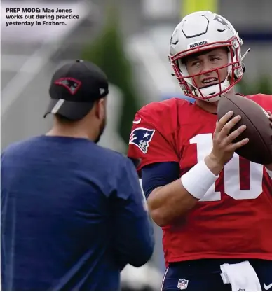  ??  ?? PREP MODE: Mac Jones works out during practice yesterday in Foxboro.