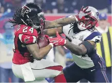  ?? ERIC GAY/THE ASSOCIATED PRESS ?? New England Patriots Dont’a Hightower, right, pressures Atlanta Falcons running back Devonta Freeman during the second half of Super Bowl LI on Sunday in Houston.